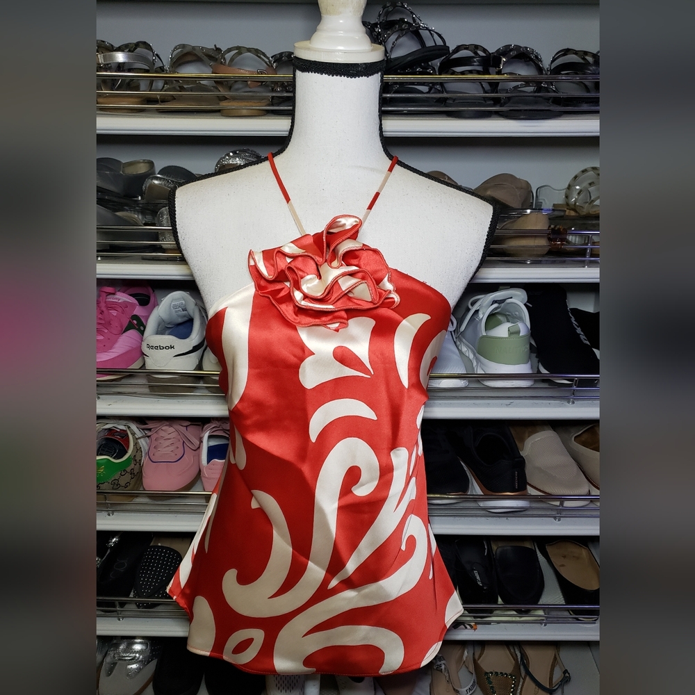 Satin top with decorative flower detail.